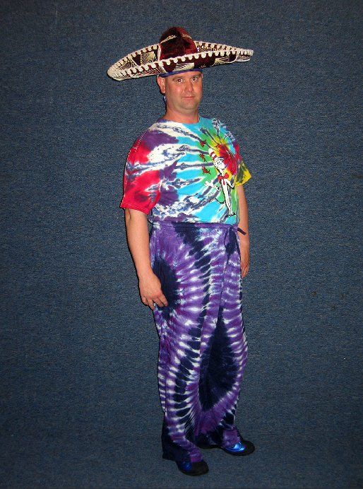 A man wearing a sombrero and tie dye pants