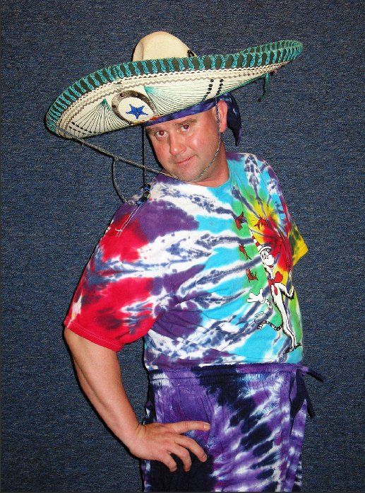 A man wearing a sombrero and a tie dye shirt