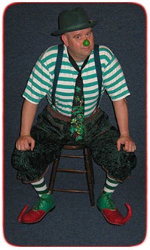 A man dressed as a clown is sitting on a stool