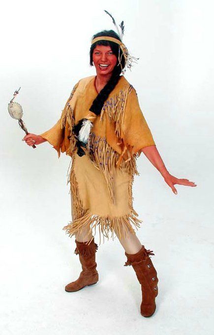 A woman in a native american costume is holding a rattle