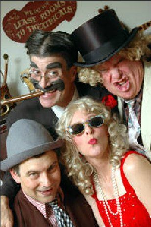 A group of people are posing for a picture in front of a sign that says lease rooms to historicals.