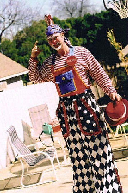A man in a clown costume is standing in front of a basketball hoop