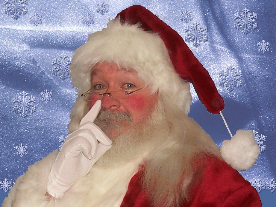 A man dressed as santa claus holds his finger to his nose