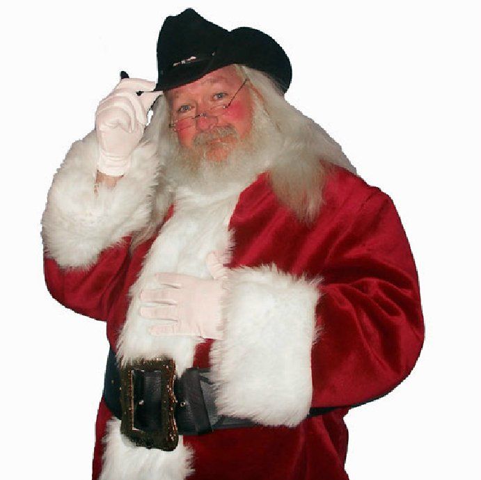 A man dressed as santa claus is talking on a cell phone