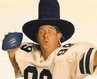 A football player wearing a cowboy hat and holding a football.