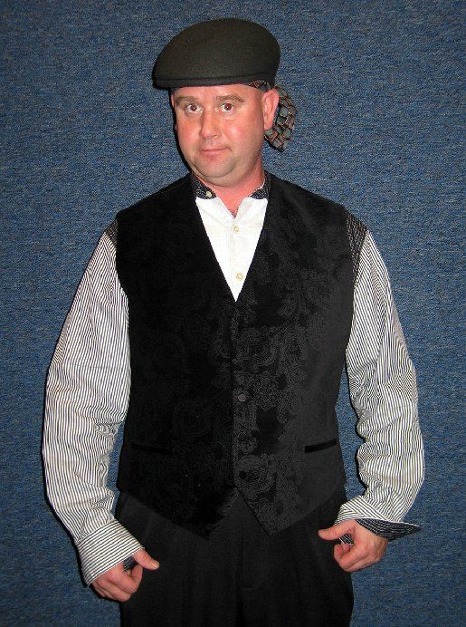A man wearing a black vest and a black hat