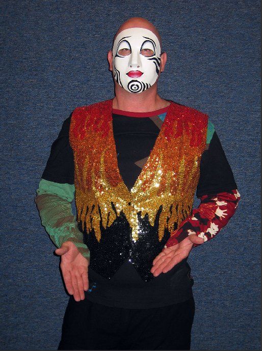 A man with a mask on his face is wearing a colorful vest