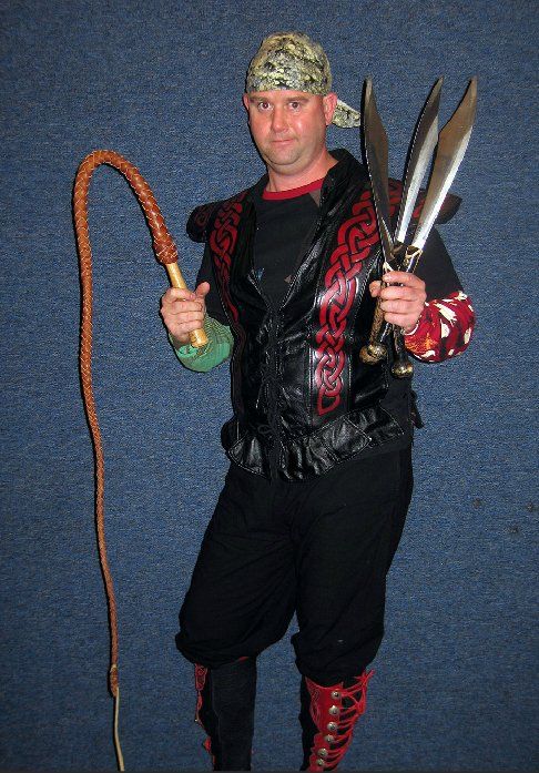 A man holding a whip and a pair of scissors