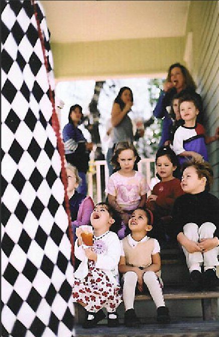 A group of children are sitting on a set of stairs