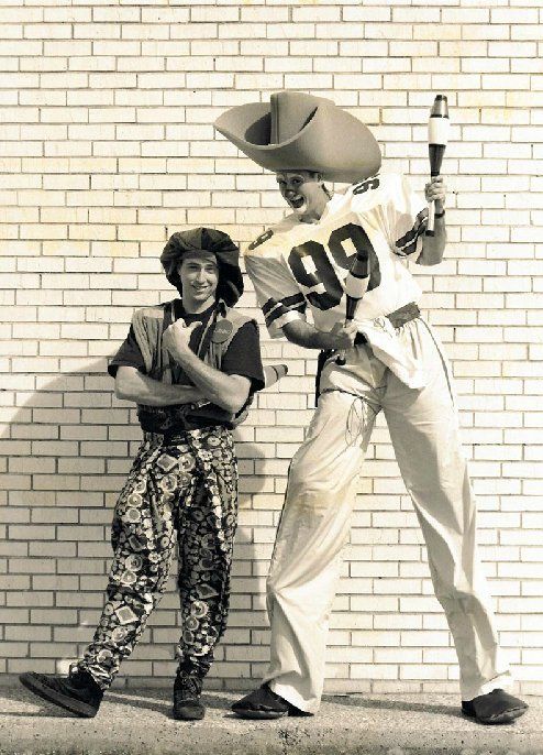 A man on stilts with the number 99 on his jersey