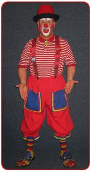 A man dressed as a clown is standing with his hands outstretched