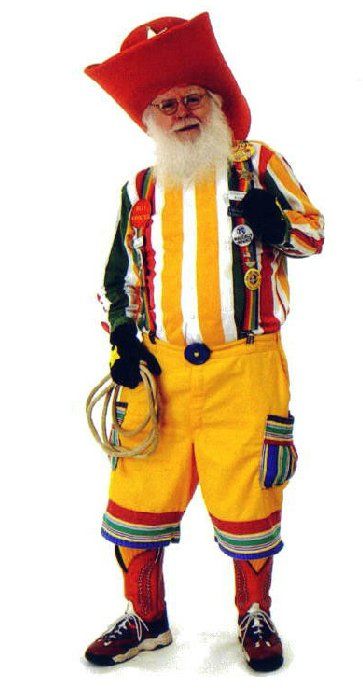 A man in a clown costume is holding a lasso
