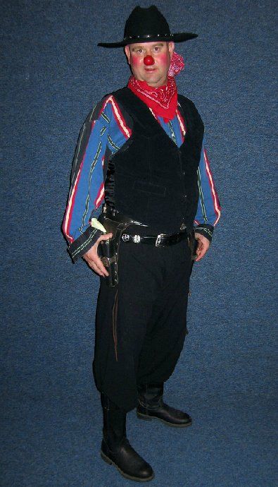 A man dressed as a cowboy with a red nose