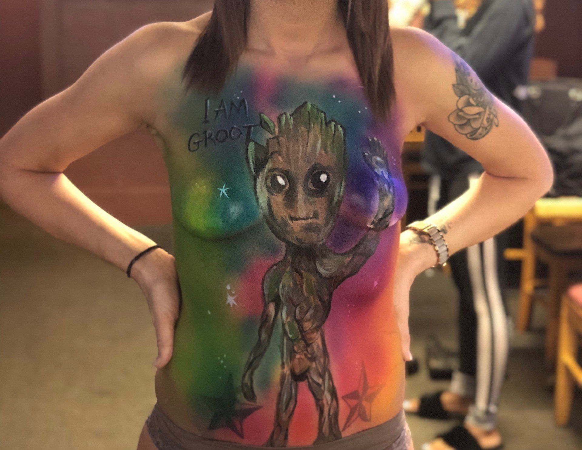 A woman has groot painted on her body