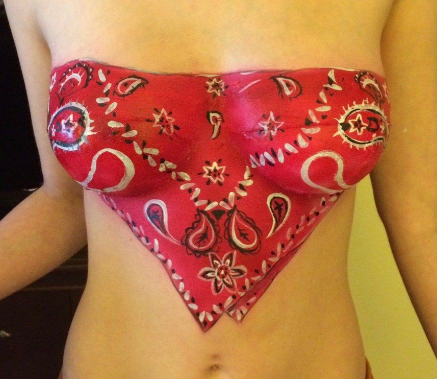 A woman has a red bandana painted on her chest
