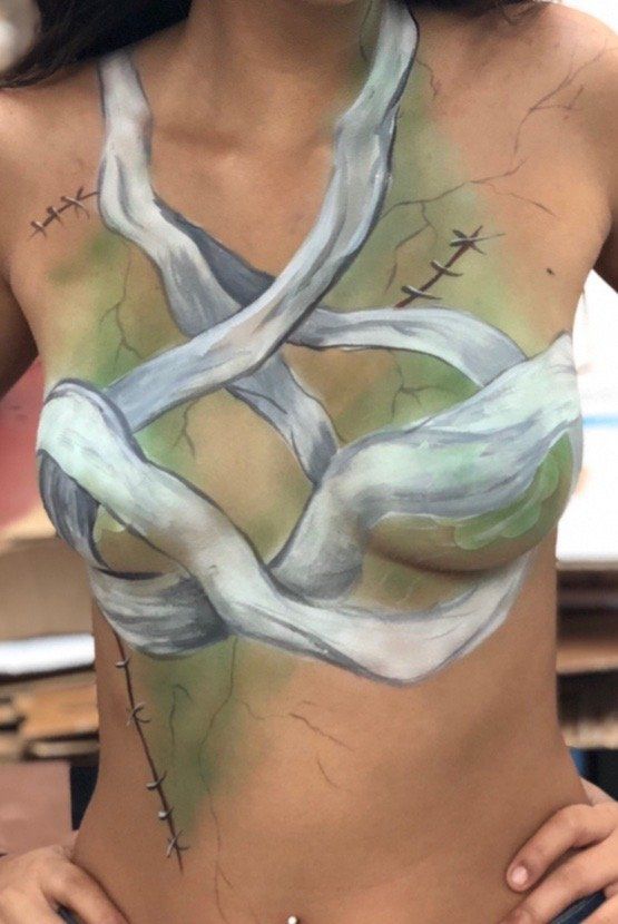 A woman with her body painted like a mummy.