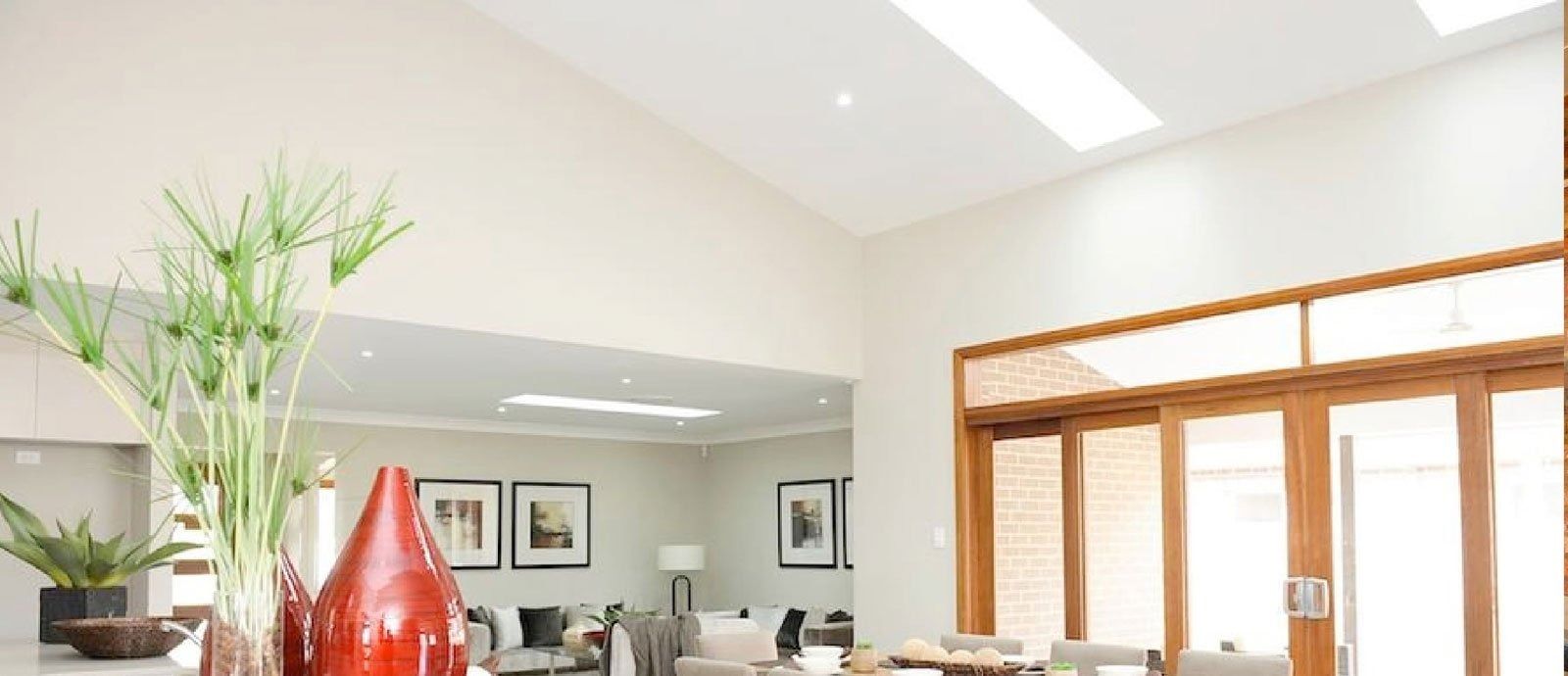 A Living Room With A Lot Of Windows And A Vase With Plants In It — The Woolmen In Alstonville, NSW