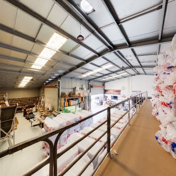 A Large Warehouse With Lots Of Boxes On The Floor — The Woolmen In Byron Bay, NSW