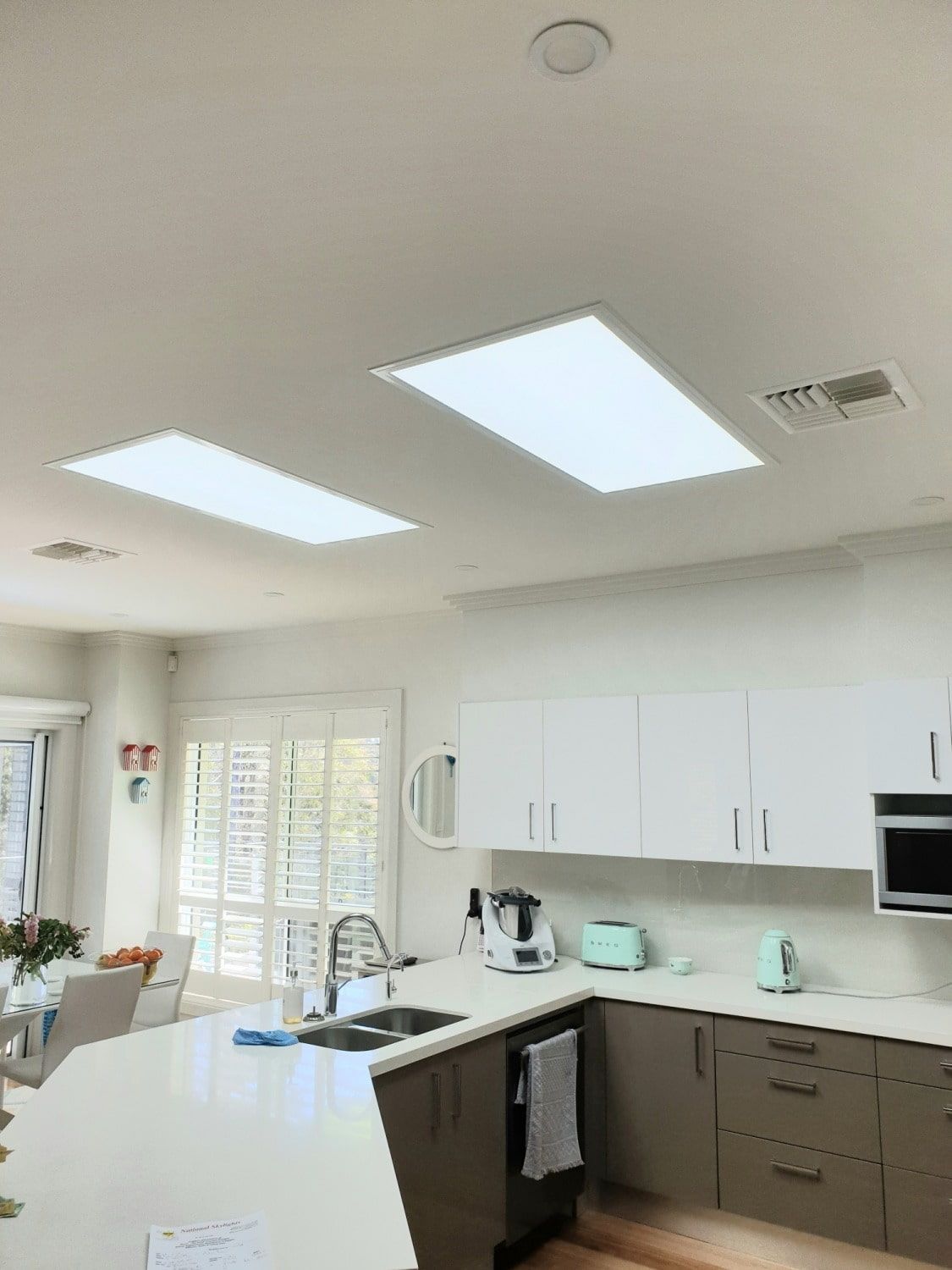 A Kitchen With White Cabinets, A Sink, And A Microwave — The Woolmen In Murwillumbah, NSW