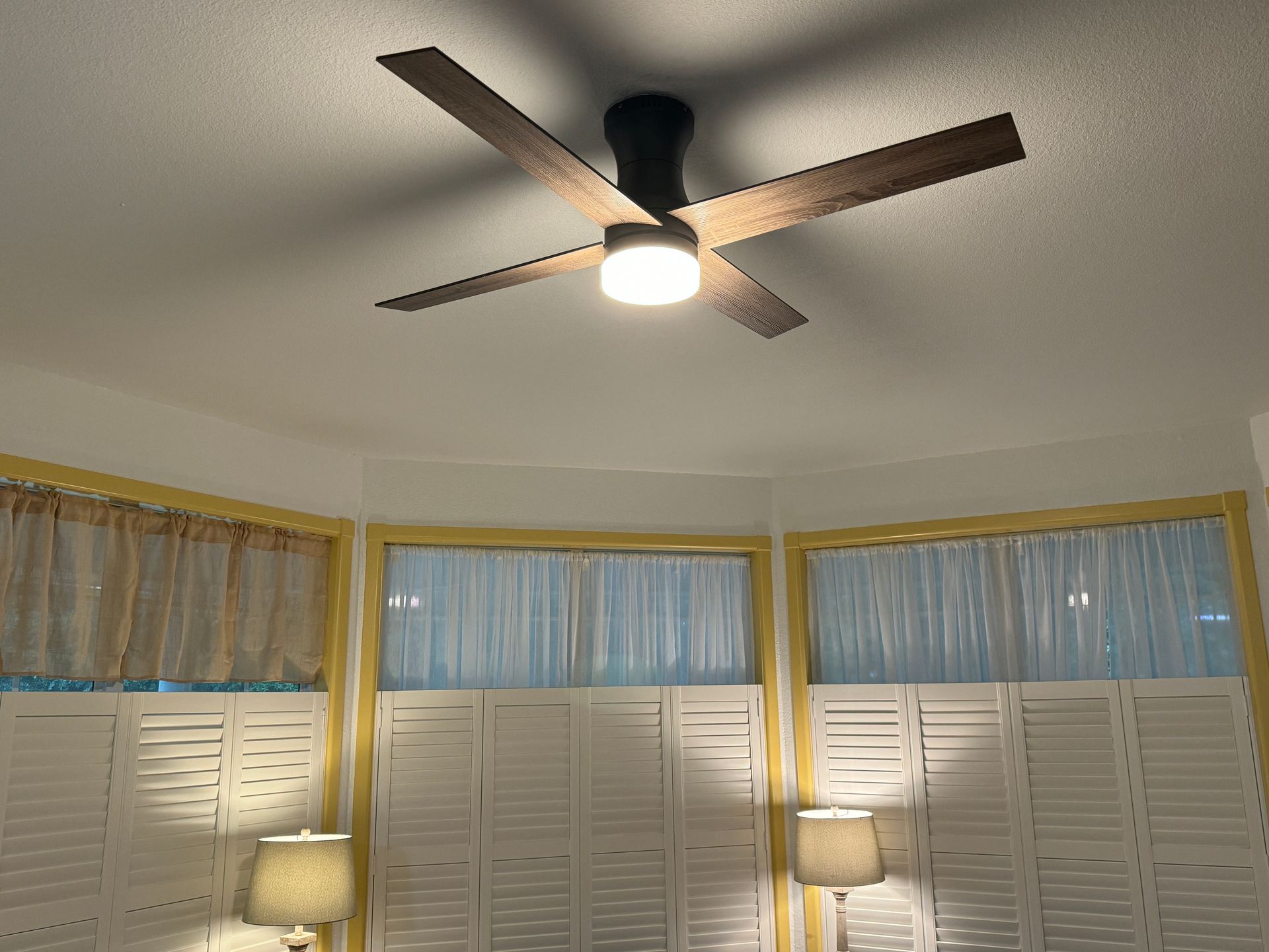 A wooden deck with a table and chairs on it.