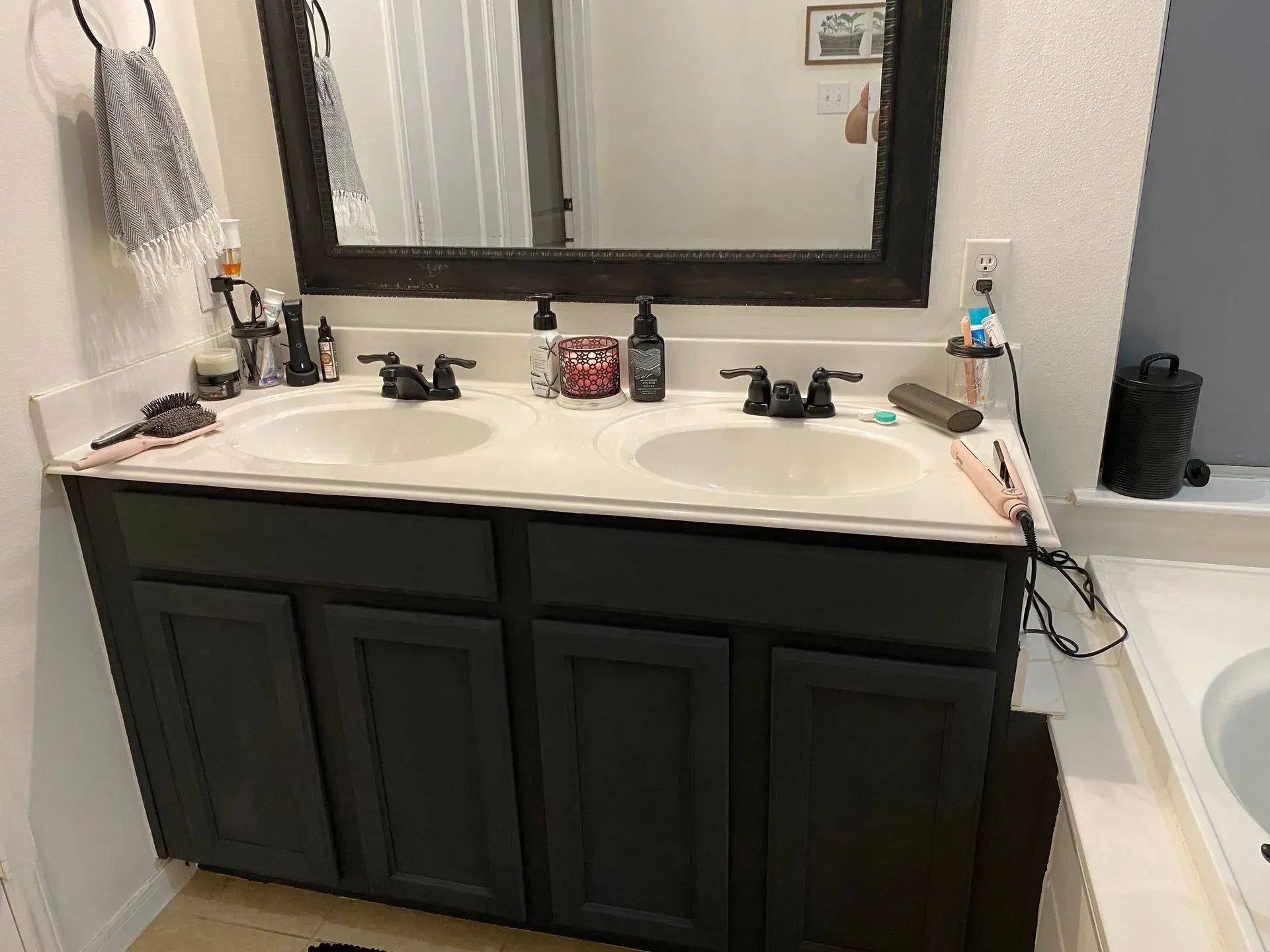 A bathroom with two sinks and a mirror.