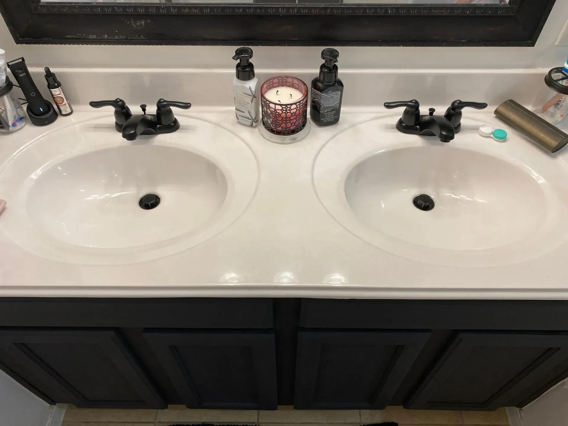 A bathroom with two sinks and a candle on the counter.