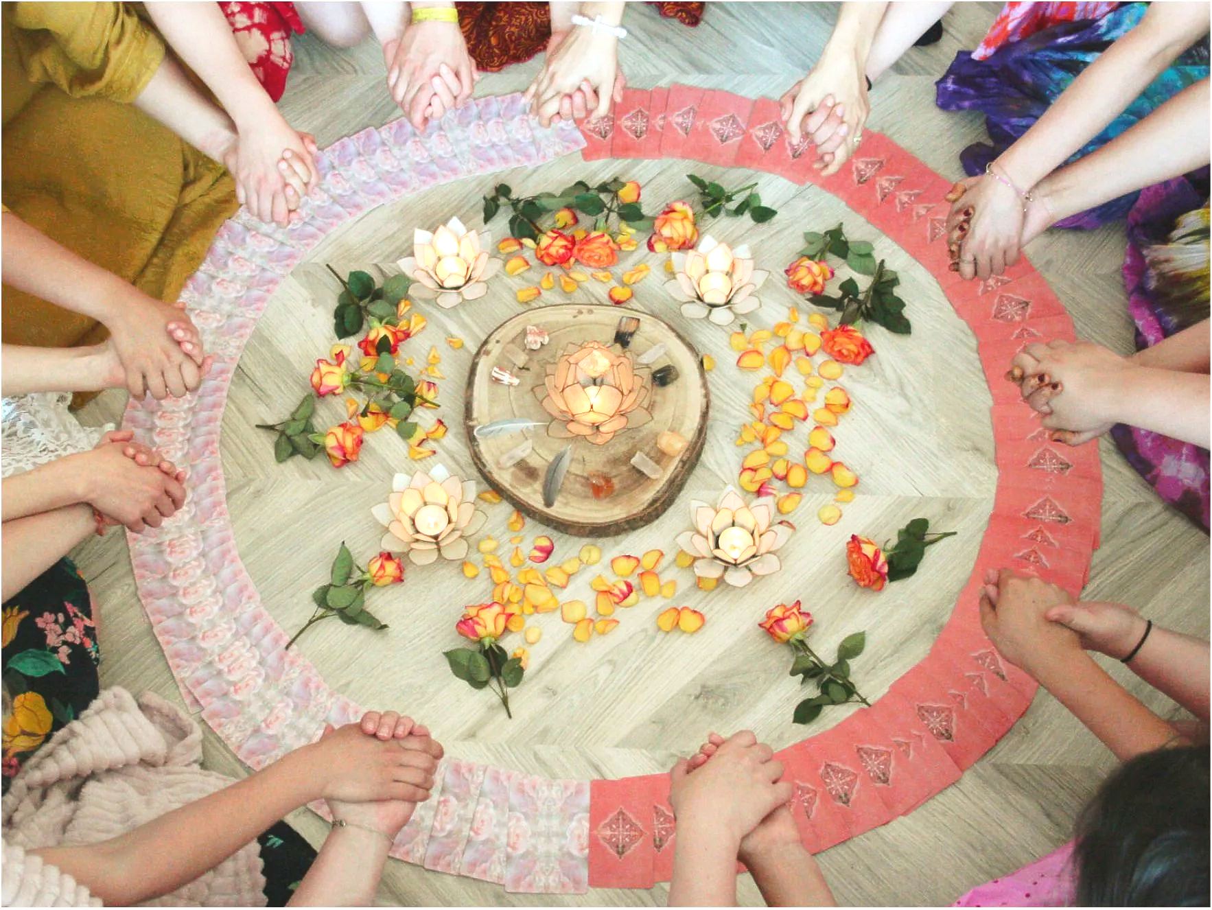 Women circle with meditation pillows on the floor. Shamanic drum, altar and plants.