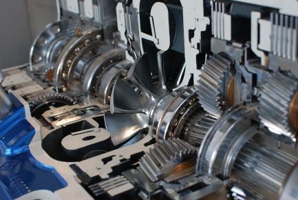 Close-up of shiny metallic gears and turbine parts in a machine assembly