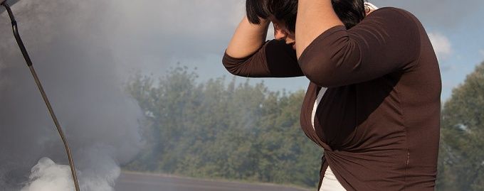 Person in shock as smoke billows from their car's engine