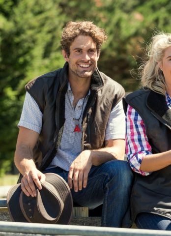 A person wearing rubber boots is standing on a blue tray.
