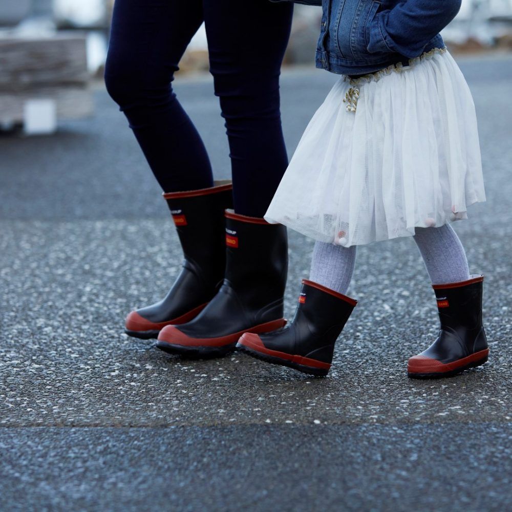 A woman and a little girl wearing rain boots