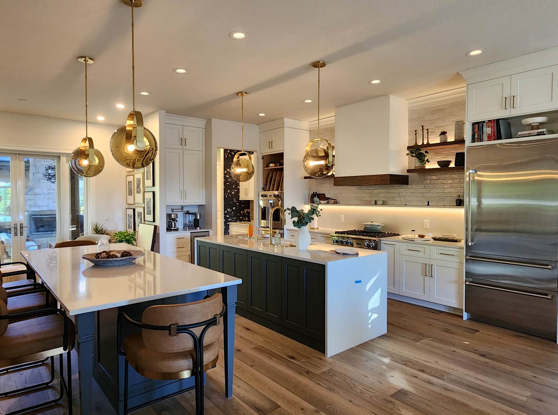 Modern bathroom with dark floating vanity, large mirror, and white tile floor.