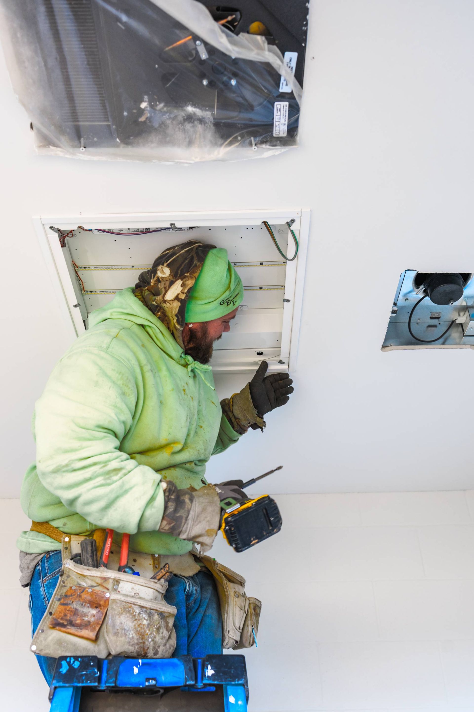 A generator is sitting outside of a building next to a tent.