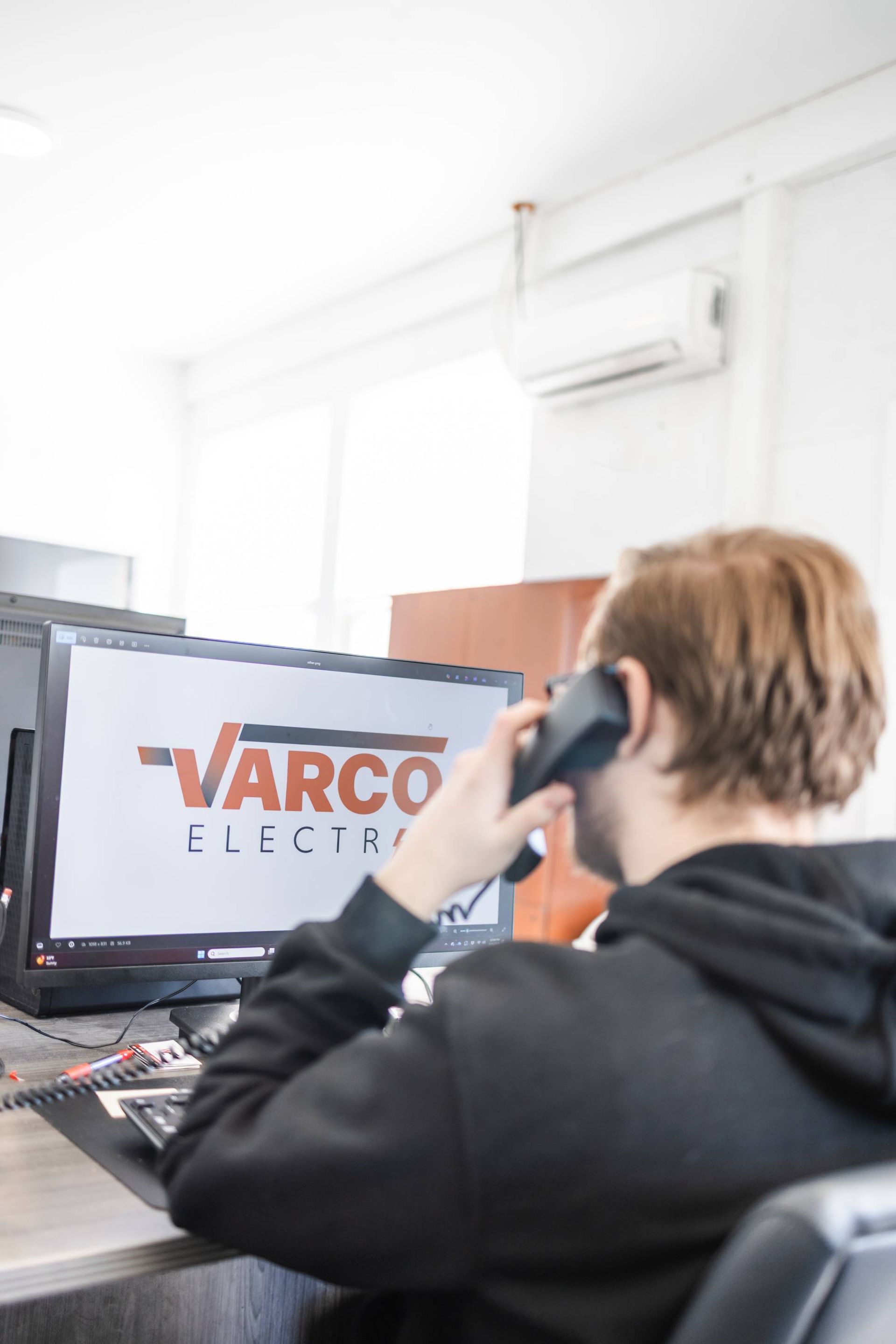 Person on the phone in office with 