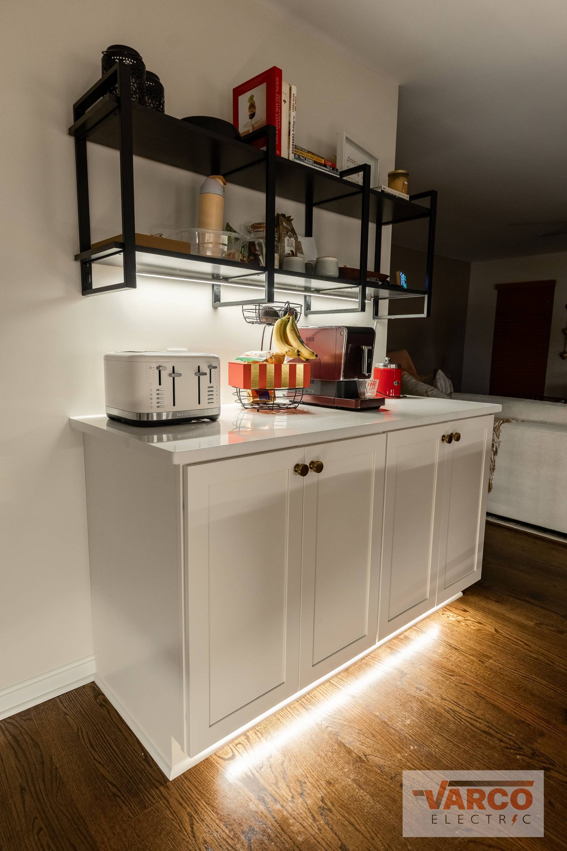 Two electric cars are being charged at a charging station.