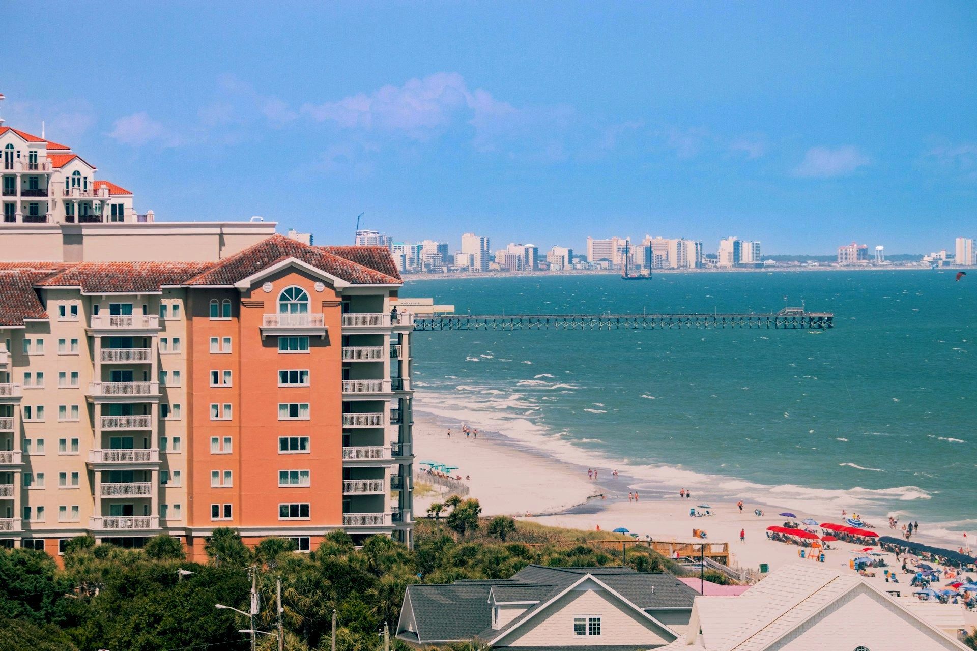 An aerial view of a beach with a large building in the foreground