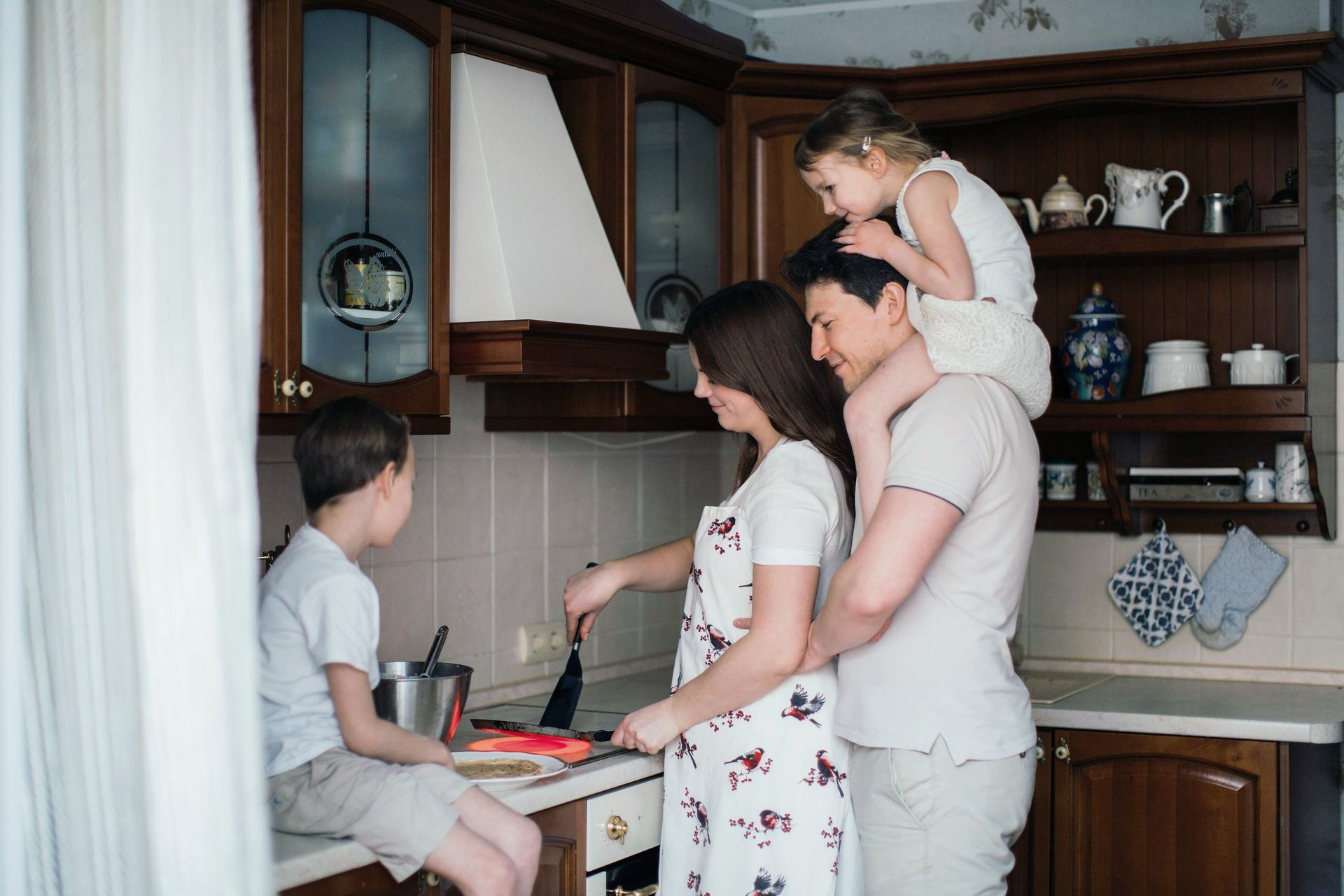 A family is cooking together in a kitchen.