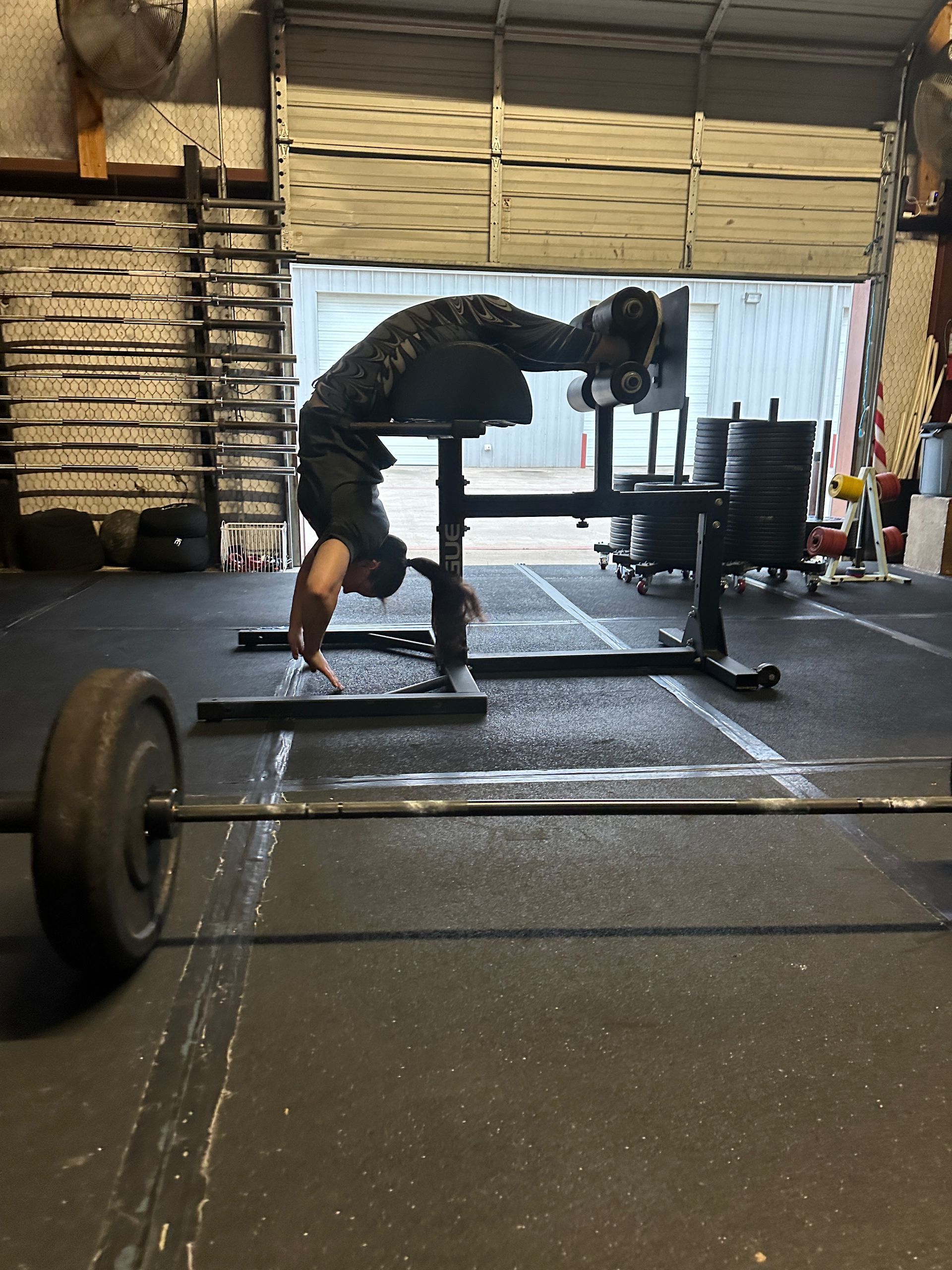 A man is doing a handstand in a gym