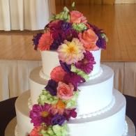 cake with colorful floral topper