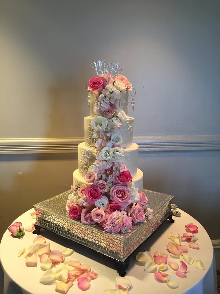 wedding cake with pink and white roses