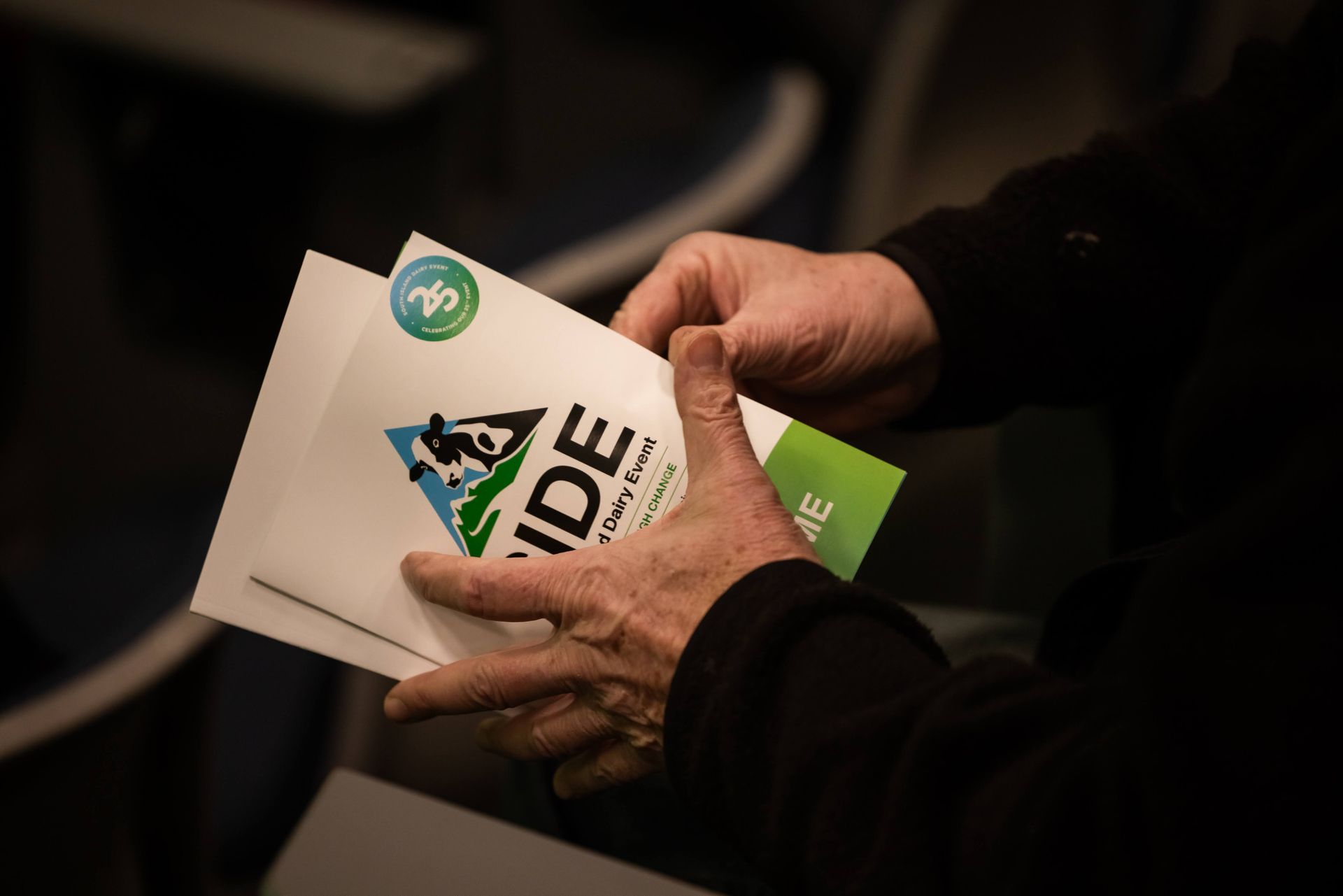 Hands holding flyers with logo 