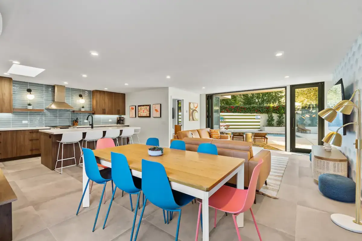 There is a table and chairs in the middle of the room.