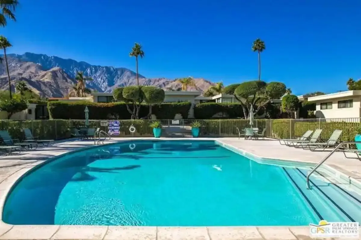 A large swimming pool with mountains in the background