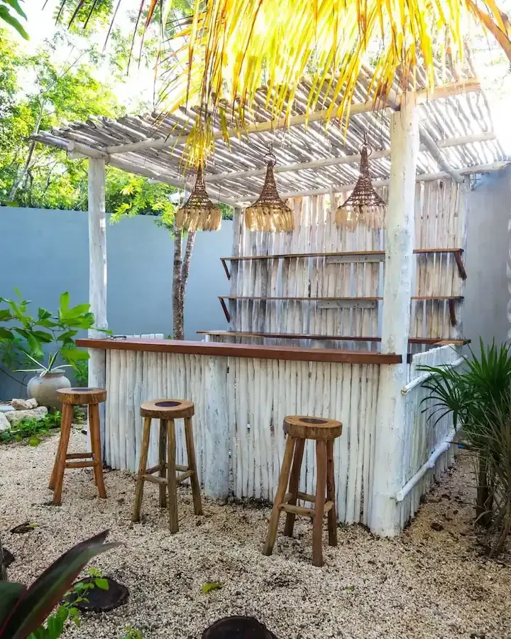 A wooden bar with stools in front of it