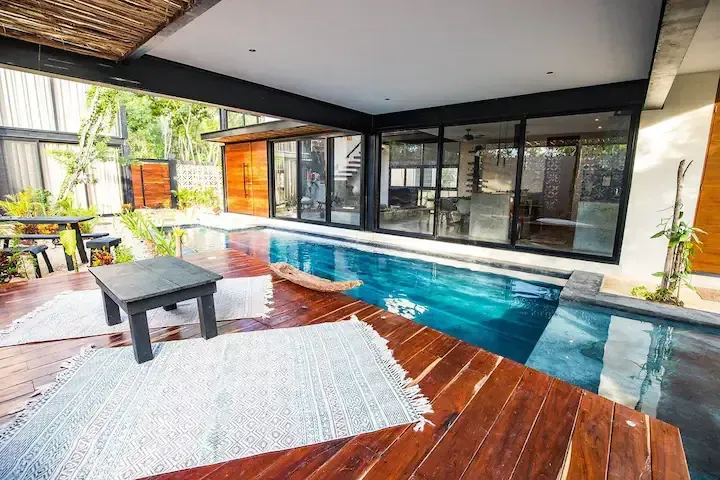 There is a large swimming pool in the middle of the house.