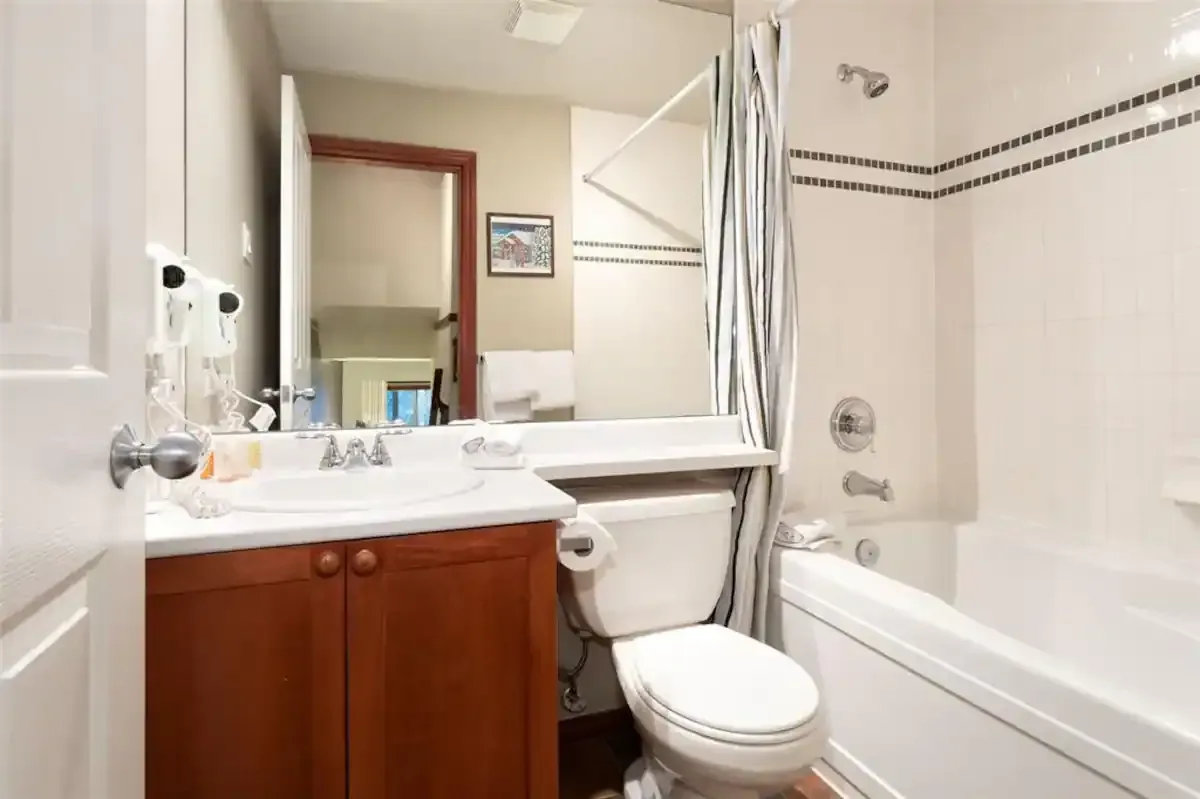 A bathroom with a toilet , sink and bathtub