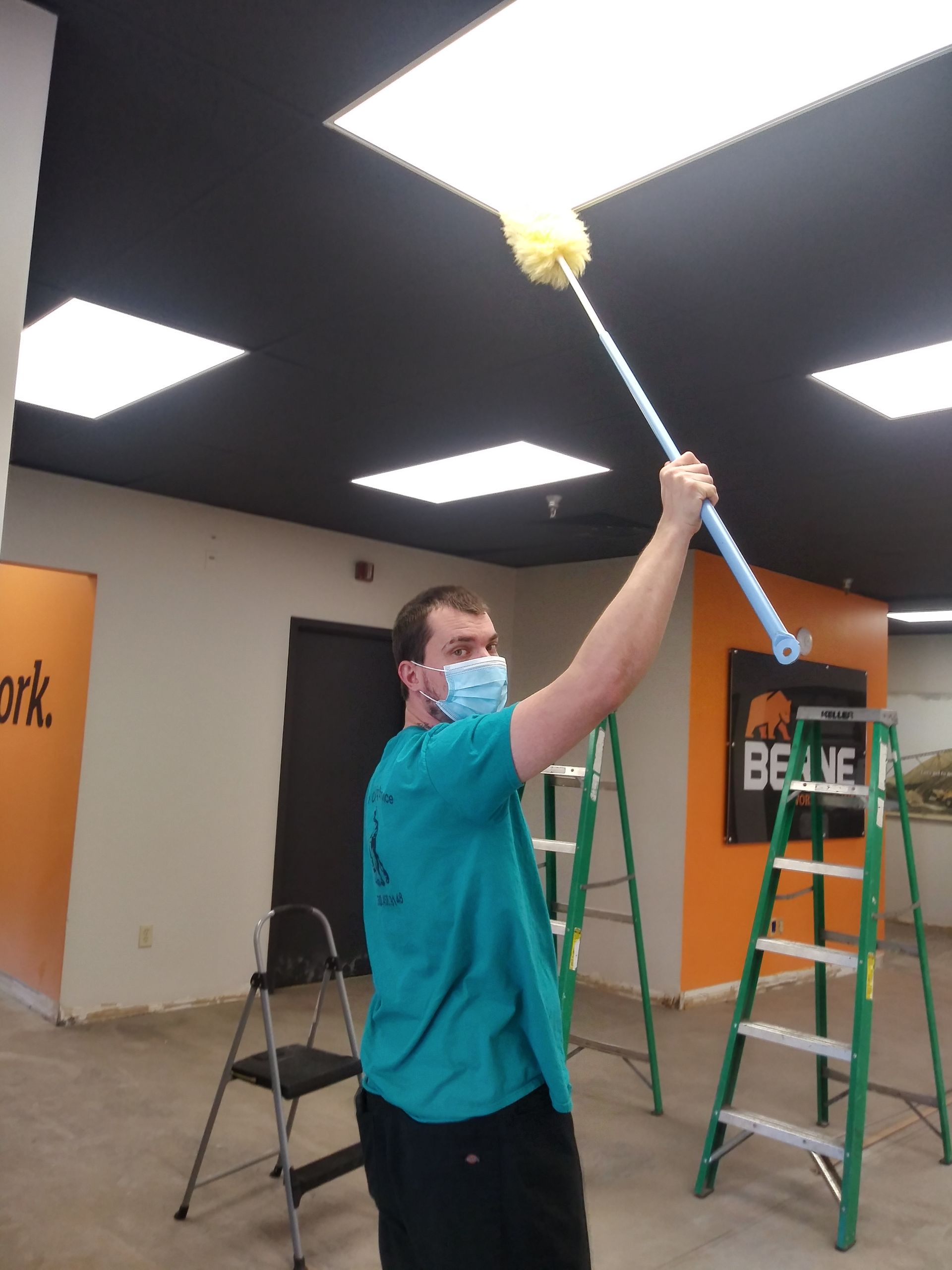 janitor dusting lights