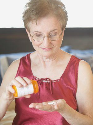 elderly woman taking antibiotics