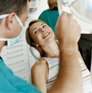 woman laying on chair smiling at dentist