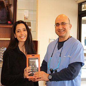 Dr. Haddad and patient taking picture at Sewell Dental
